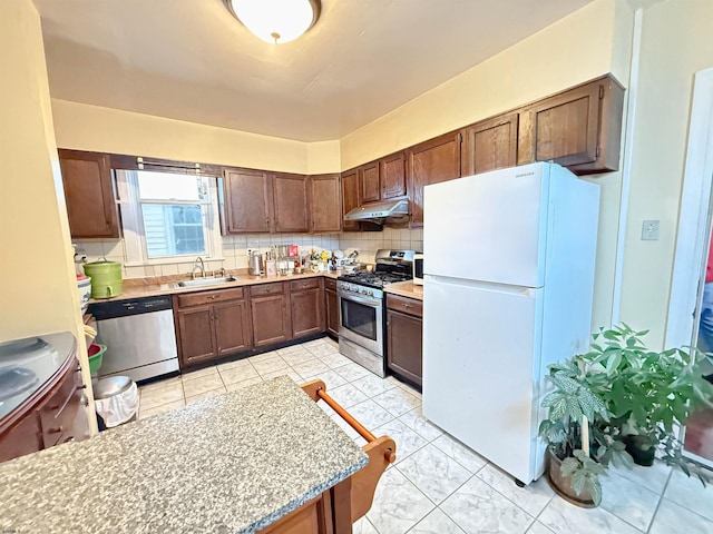 kitchen with backsplash, sink, and stainless steel appliances