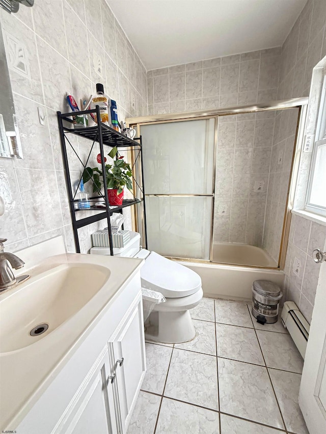 full bathroom featuring baseboard heating, tile patterned flooring, enclosed tub / shower combo, vanity, and tile walls