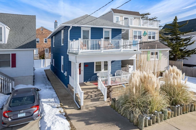 view of front of house featuring covered porch and a balcony