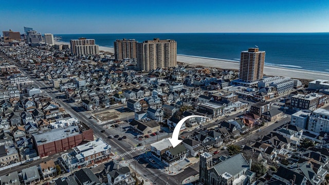 drone / aerial view with a view of the beach and a water view