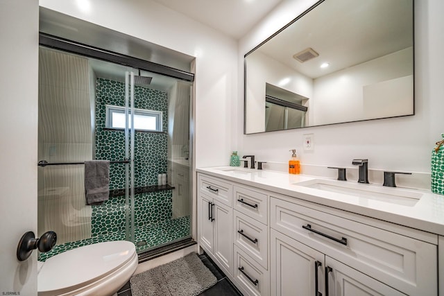 bathroom with vanity, toilet, and walk in shower