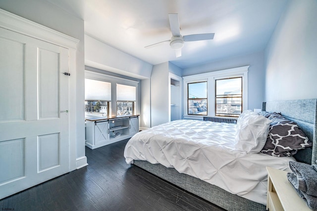 bedroom with ceiling fan and dark hardwood / wood-style flooring