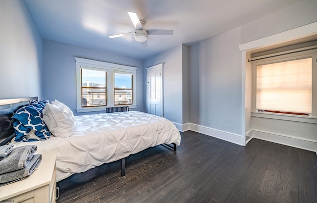 bedroom with dark hardwood / wood-style floors and ceiling fan