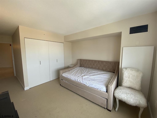 carpeted bedroom with a closet