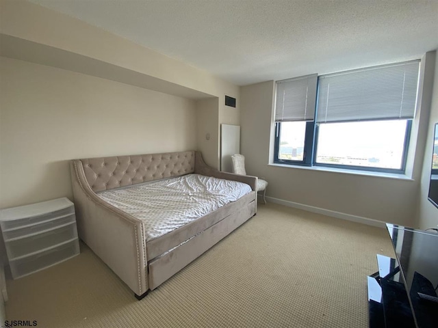 bedroom featuring light colored carpet