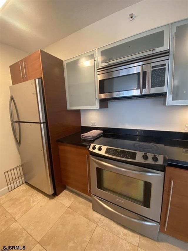 kitchen with appliances with stainless steel finishes and light tile patterned floors