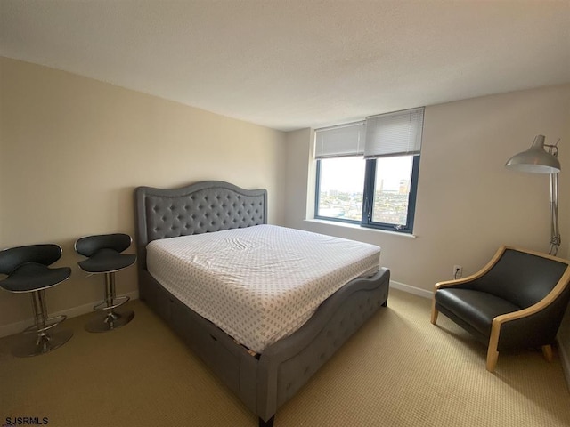 bedroom featuring light carpet