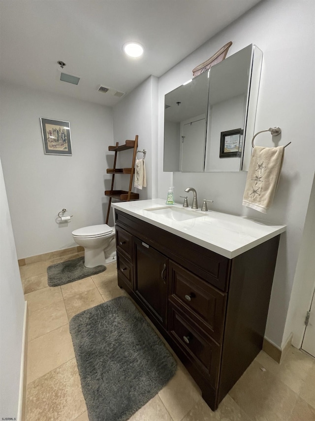 bathroom with tile patterned floors, vanity, and toilet