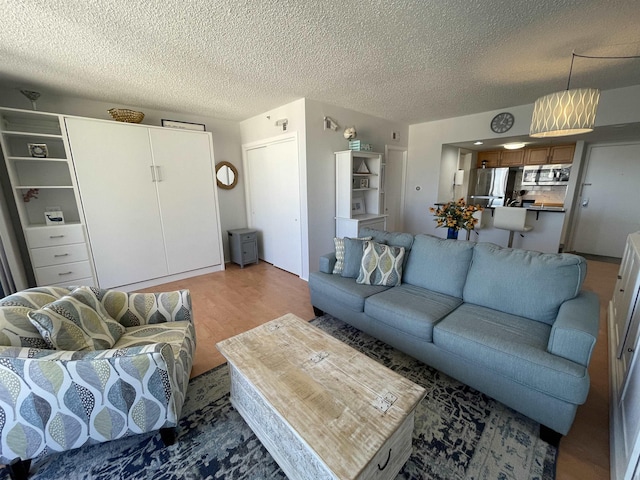 living room featuring hardwood / wood-style floors and a textured ceiling