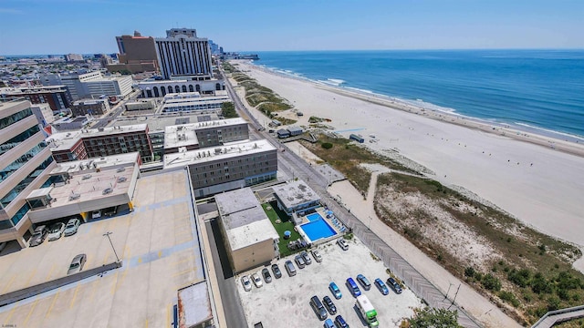 bird's eye view featuring a water view and a beach view