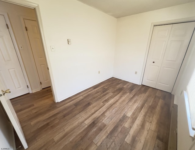 unfurnished bedroom featuring dark hardwood / wood-style floors