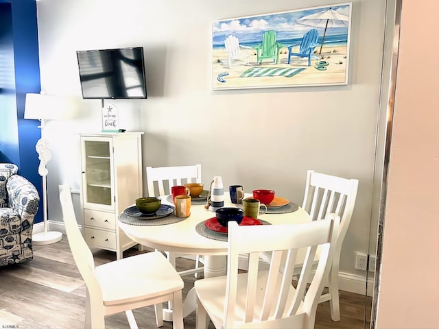 dining space featuring hardwood / wood-style flooring