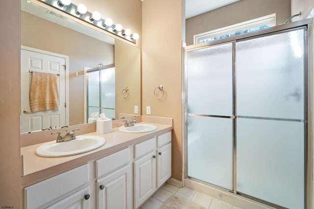 bathroom featuring tile patterned flooring, vanity, and walk in shower