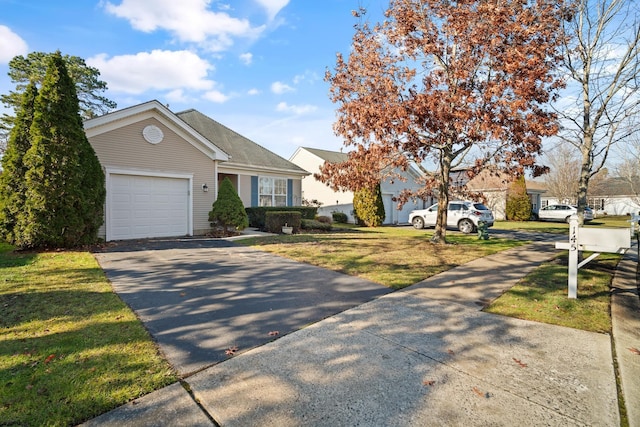 view of front of property featuring a front yard and a garage