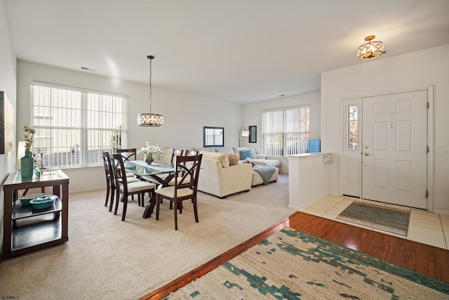 carpeted dining room with plenty of natural light