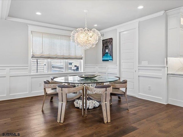 dining room featuring crown molding, dark hardwood / wood-style floors, and an inviting chandelier