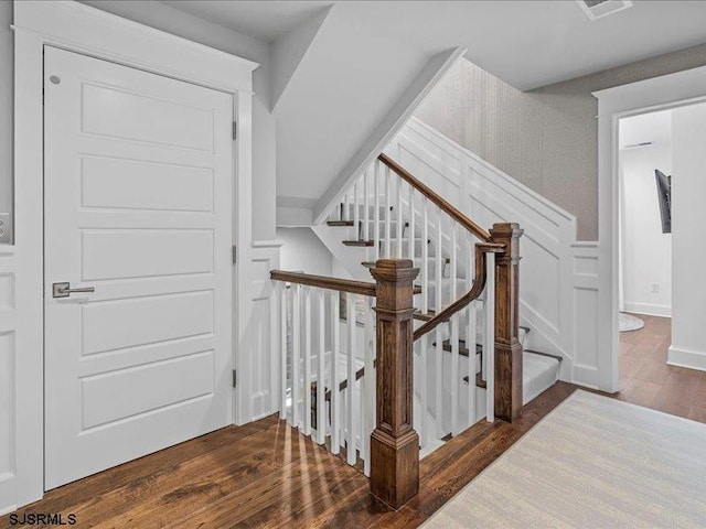 staircase with wood-type flooring