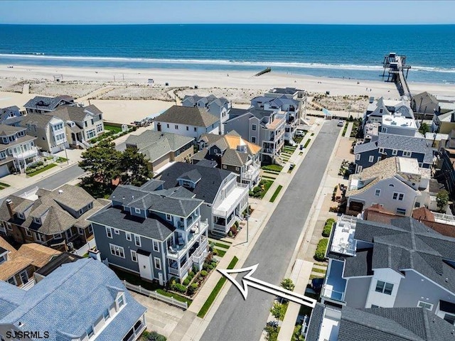 drone / aerial view featuring a view of the beach and a water view