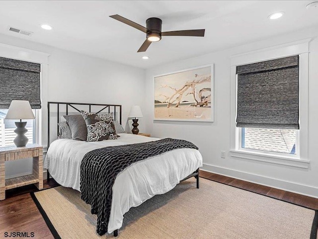 bedroom with ceiling fan and dark hardwood / wood-style flooring