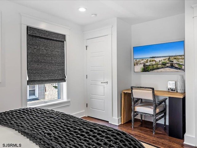 bedroom with dark hardwood / wood-style flooring