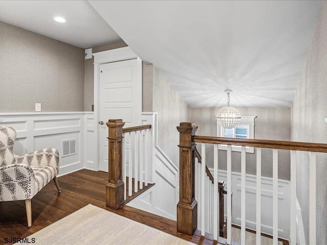 interior space featuring hardwood / wood-style flooring and a notable chandelier