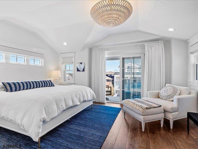 bedroom featuring access to exterior, lofted ceiling, dark hardwood / wood-style flooring, and multiple windows