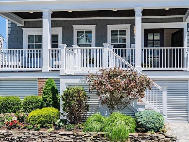 rear view of property featuring a porch