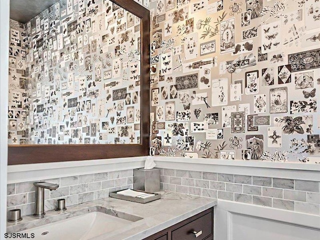 bathroom with vanity and tasteful backsplash