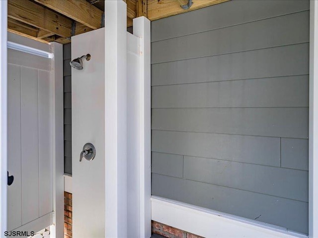 bathroom featuring wood walls