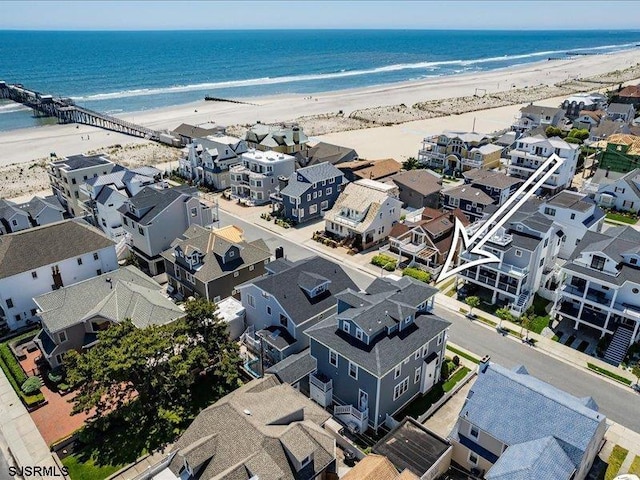 birds eye view of property with a beach view and a water view