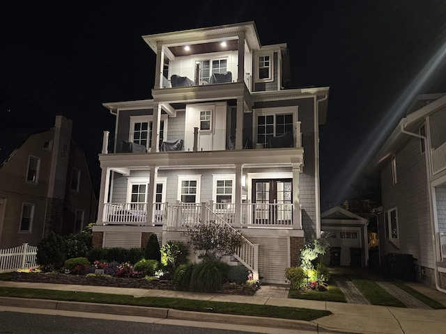 view of front of property with a balcony and french doors