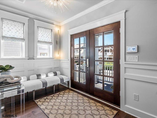 doorway featuring hardwood / wood-style flooring, a notable chandelier, crown molding, and french doors