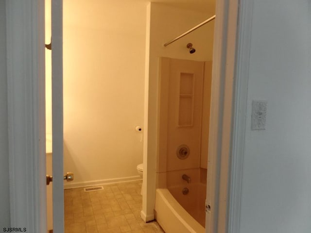 bathroom with toilet and shower / washtub combination