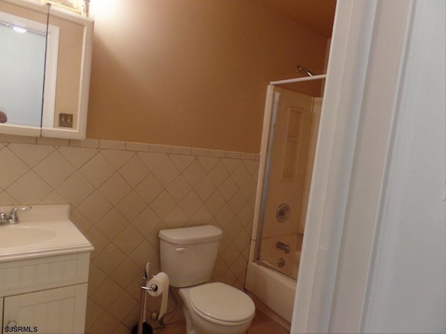 full bathroom with vanity, shower / bathtub combination, toilet, and tile walls