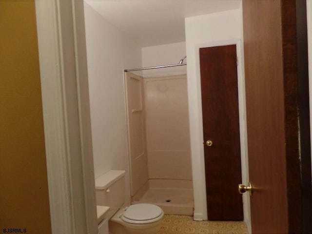 bathroom featuring toilet and walk in shower