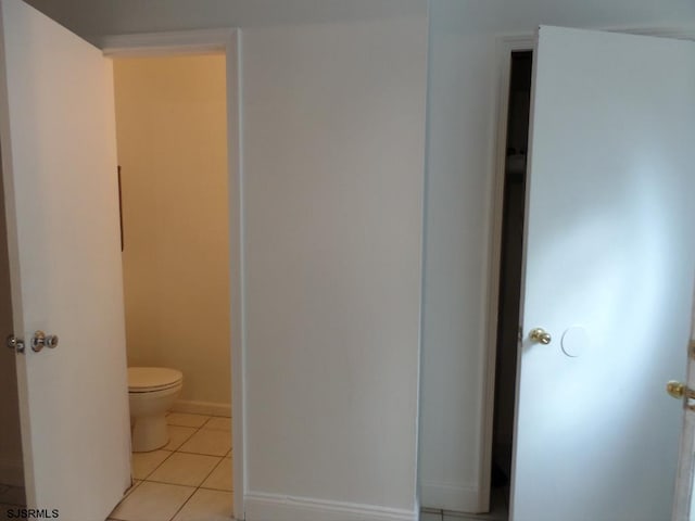 bathroom with tile patterned flooring and toilet