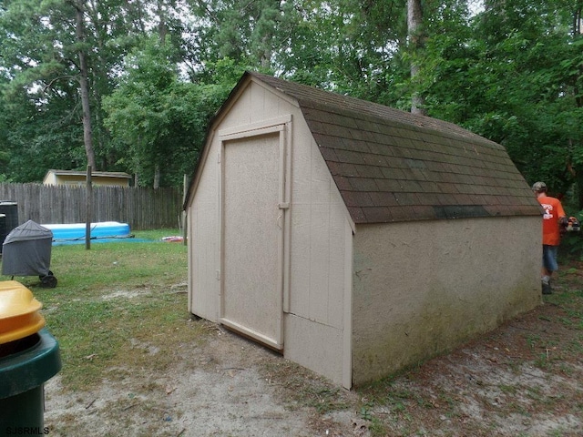 view of outdoor structure with a fenced in pool