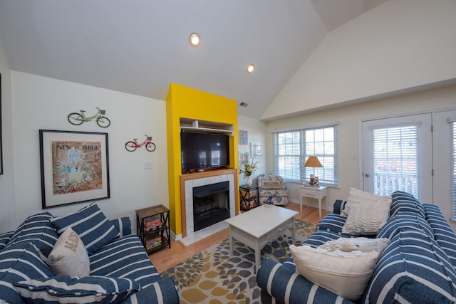 living room with light hardwood / wood-style floors and lofted ceiling