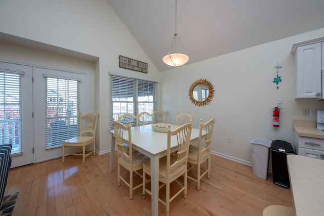 dining room featuring light hardwood / wood-style floors and vaulted ceiling