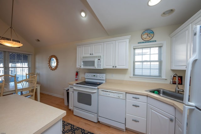 kitchen with white cabinets, white appliances, sink, and hanging light fixtures