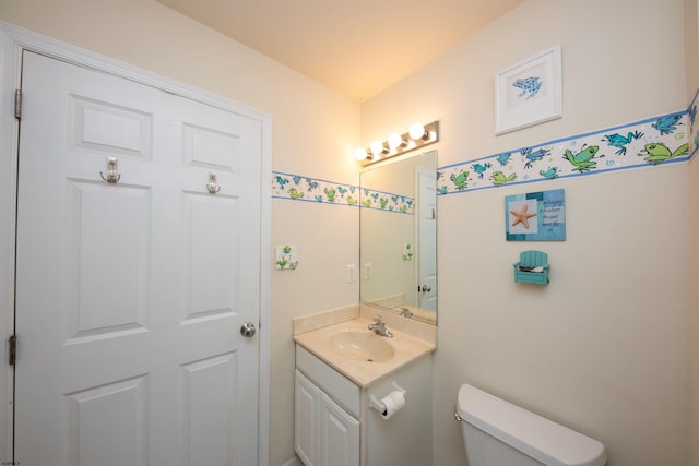 bathroom featuring vanity and toilet