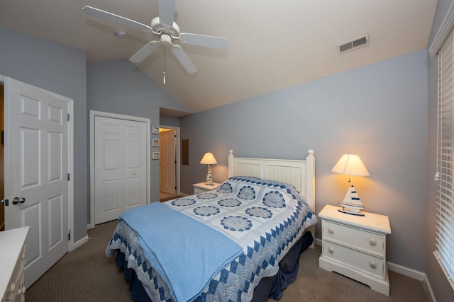 bedroom featuring dark colored carpet, ceiling fan, lofted ceiling, and a closet