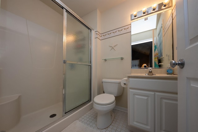 bathroom featuring tile patterned flooring, toilet, vanity, and walk in shower