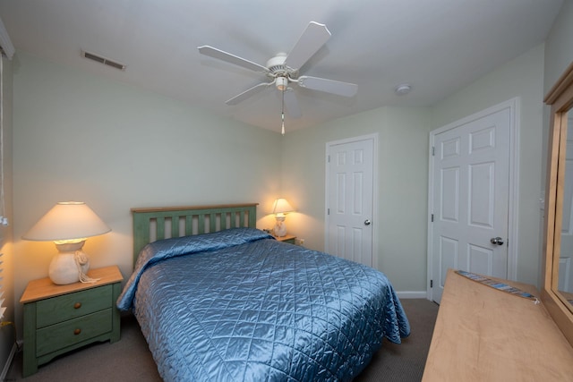 bedroom featuring ceiling fan and dark carpet