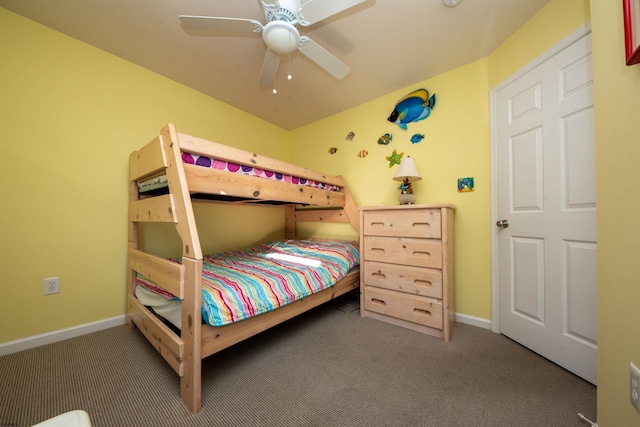 bedroom with ceiling fan and dark carpet