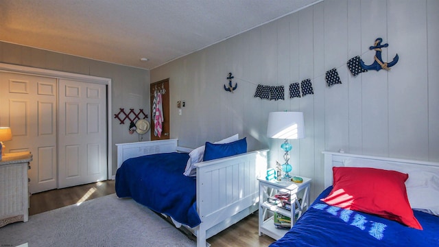 bedroom with hardwood / wood-style flooring and a closet