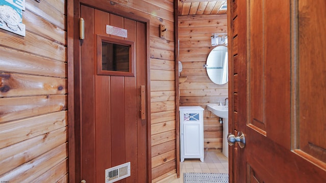 bathroom featuring wood walls