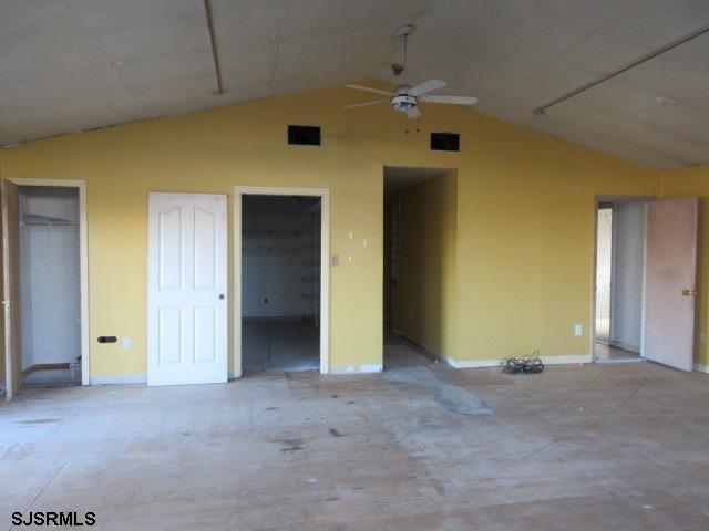 unfurnished bedroom featuring ceiling fan and vaulted ceiling