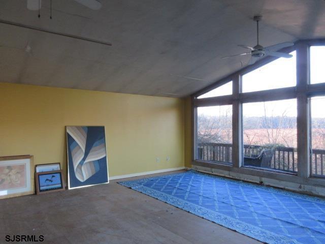 additional living space with vaulted ceiling and ceiling fan