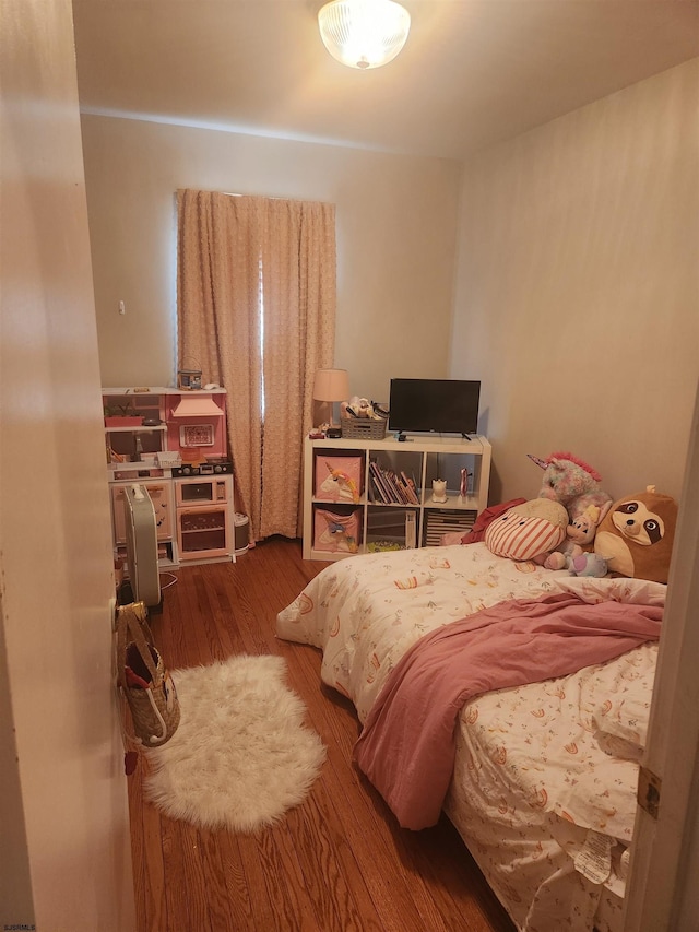 bedroom with wood-type flooring